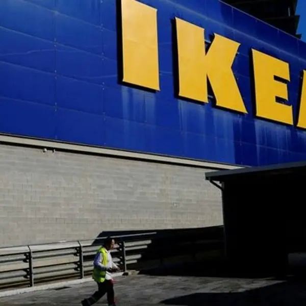 A worker walks past the façade of an IKEA store in Barcelona, Spain, April 26, 2024