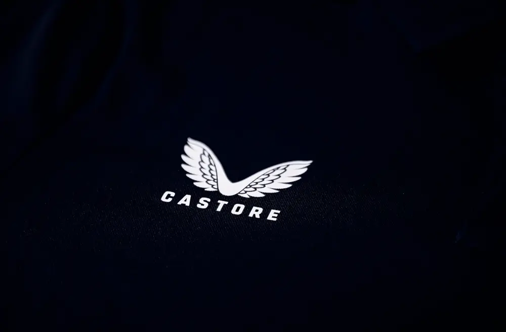 Logo blanc de Castore avec des ailes sur fond noir, lié au partenariat avec Hampshire Cricket