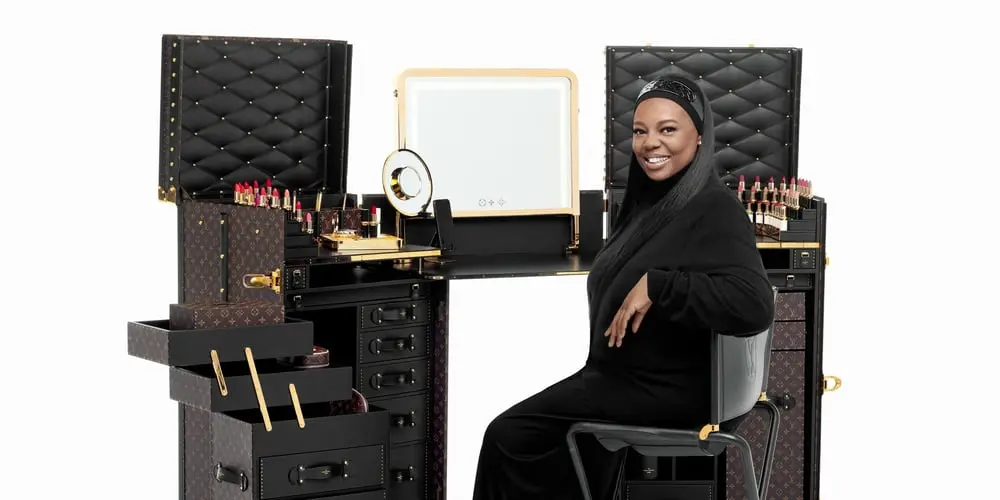 Dame Pat McGrath with a Louis Vuitton makeup trunk