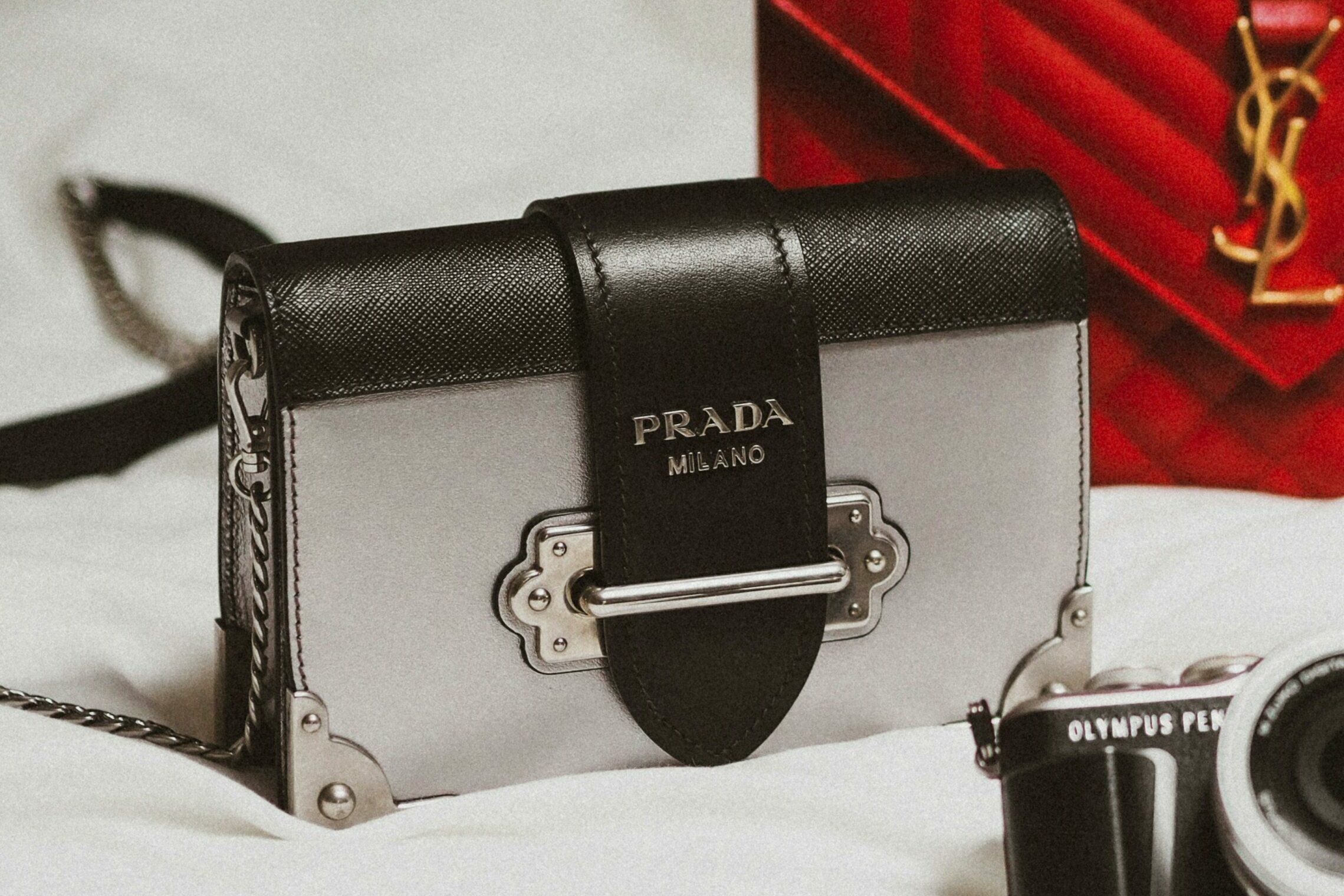 Sac en cuir gris posé sur un magazine de mode, illustration du retour des sacs luxe accessibles